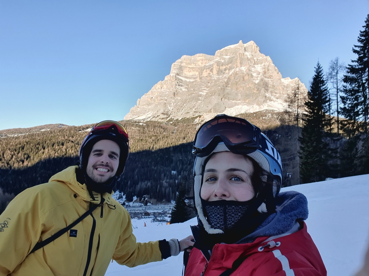 Francesco Campaioli (left) and his sister (right) pictured on a ski slope in Europe with a green forest behind them. 