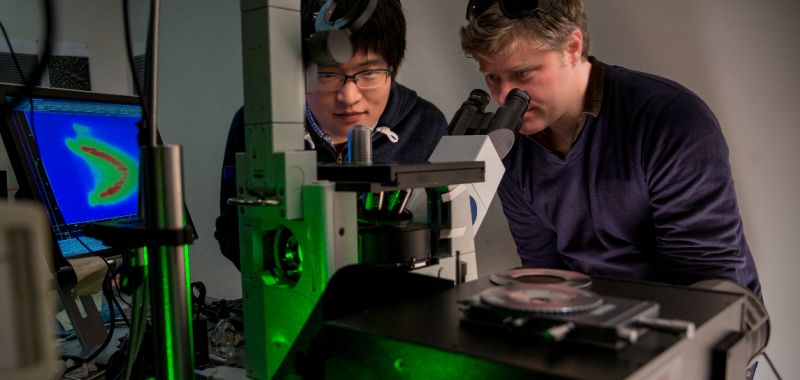 James Hutchison (right) working in a laboratory at the University of Melbourne