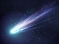 An image of a comet with a green head and purple tail in space