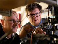 Jamie Laird (left) and Rohan Hudson (right) working with spectroscopy equipment at the University of Melbourne